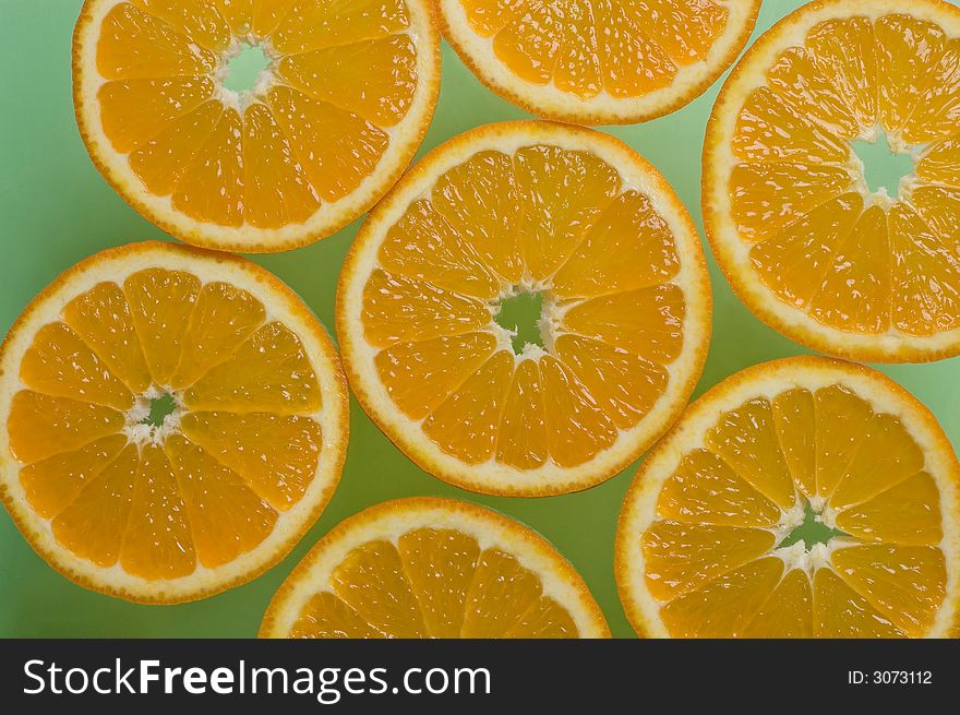 Orange slices on the green table. Orange slices on the green table
