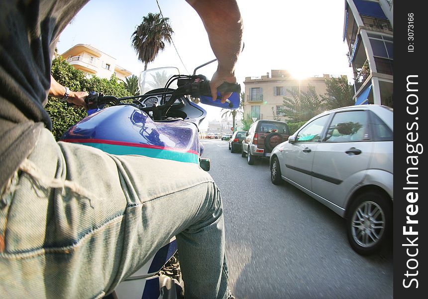 Man rides in street on his motorbike, sitges, spain. Man rides in street on his motorbike, sitges, spain