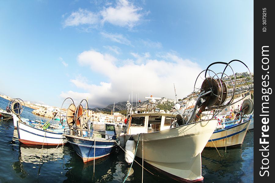 Pretty fishing boats shot with fisheye lens in marseille, france. Pretty fishing boats shot with fisheye lens in marseille, france