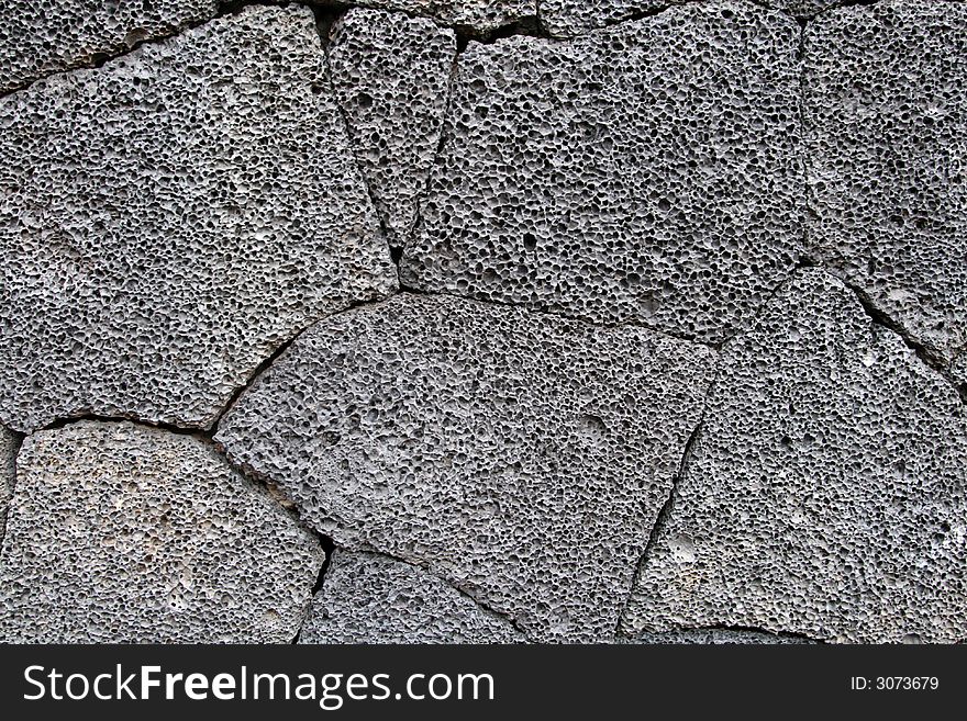 Volcanic wall stones background and texture