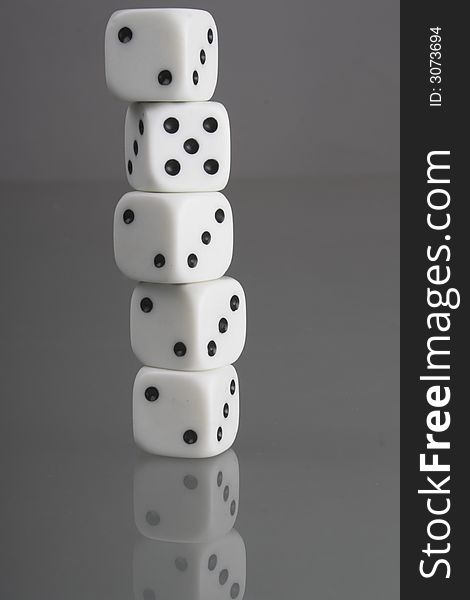 Five dice on a black glass