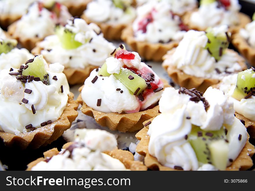 Delicious fruit tart with whipped cream on tray