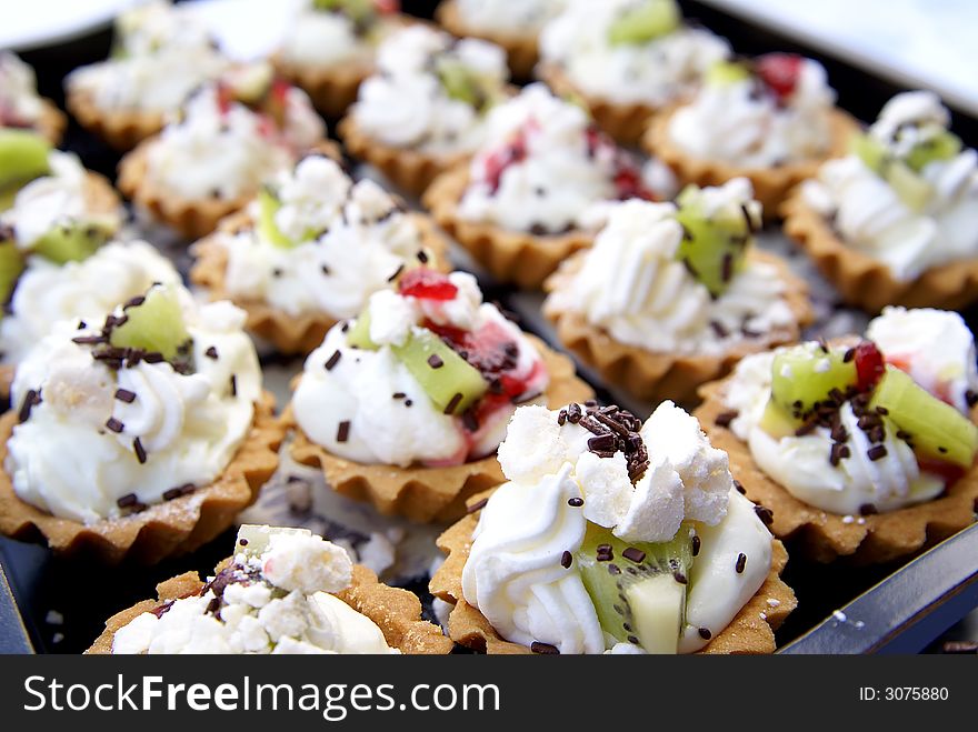 Delicious fruit tart with whipped cream on tray