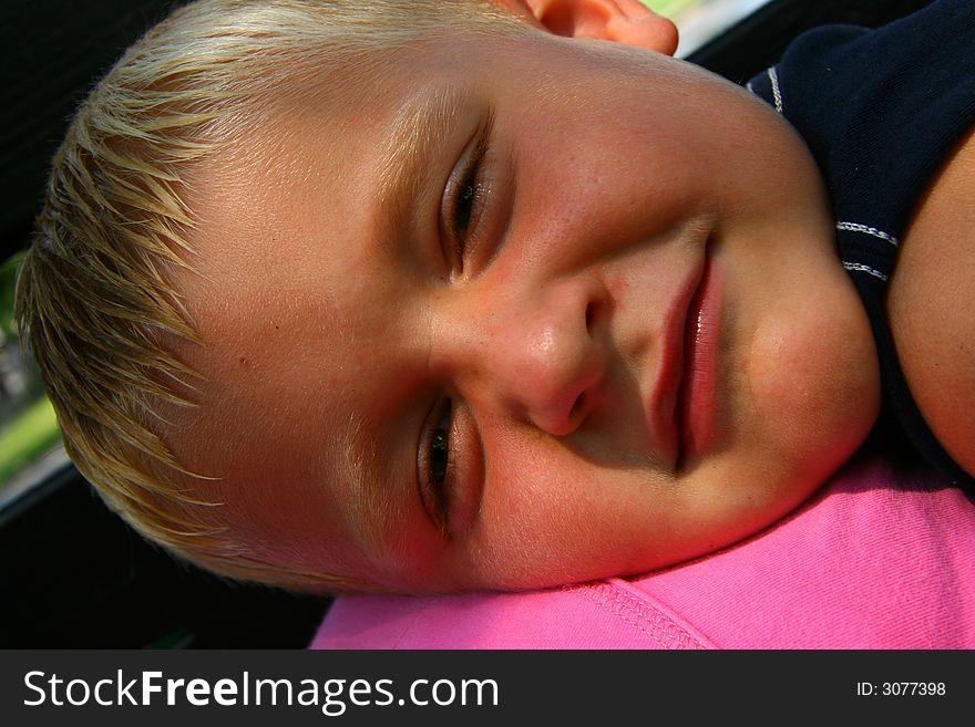 Boy Laying On The Bench