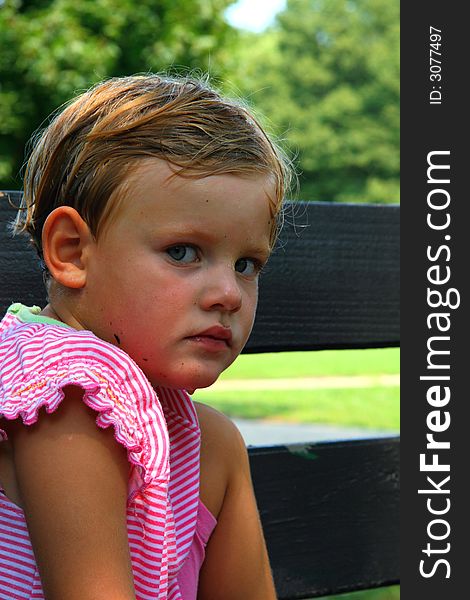 Portrait of tired girl sitting on the bench in the park. Portrait of tired girl sitting on the bench in the park