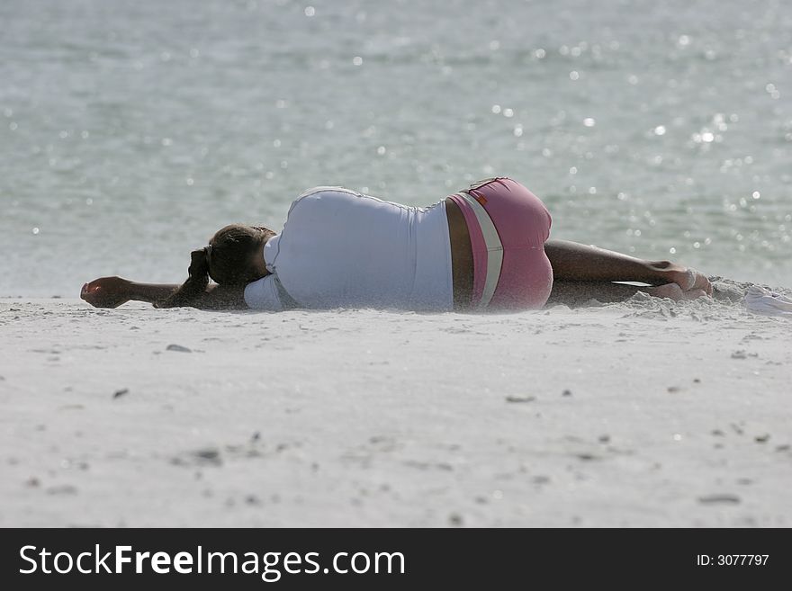 Woman sleeping on the beach in white sand