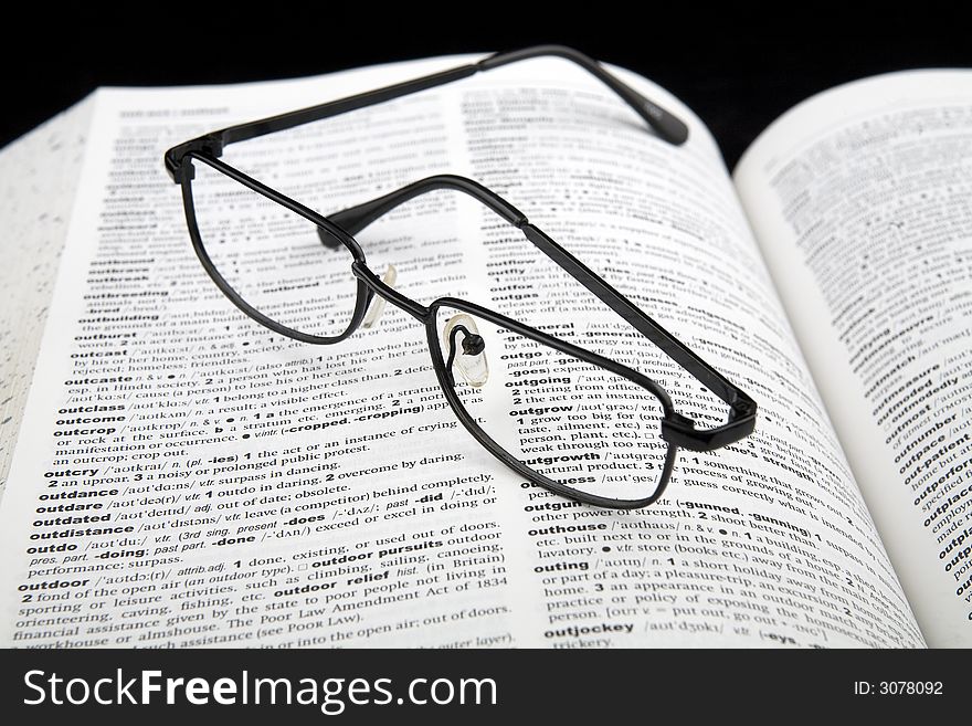 A pair of spectacles on a book. A pair of spectacles on a book