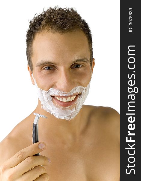 Young, handsome man smiling and looking at camera. Holding safety razor. White background, front view. Young, handsome man smiling and looking at camera. Holding safety razor. White background, front view