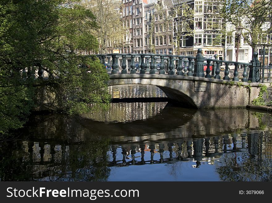 Reflection of bridge in a Amsterdam canal. Reflection of bridge in a Amsterdam canal