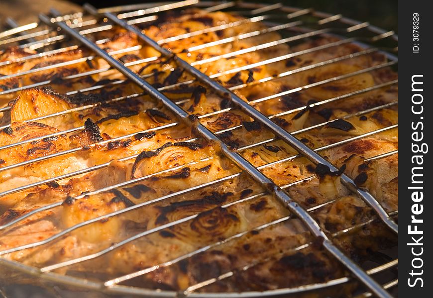 Barbecue with pork and onion close-up. Barbecue with pork and onion close-up