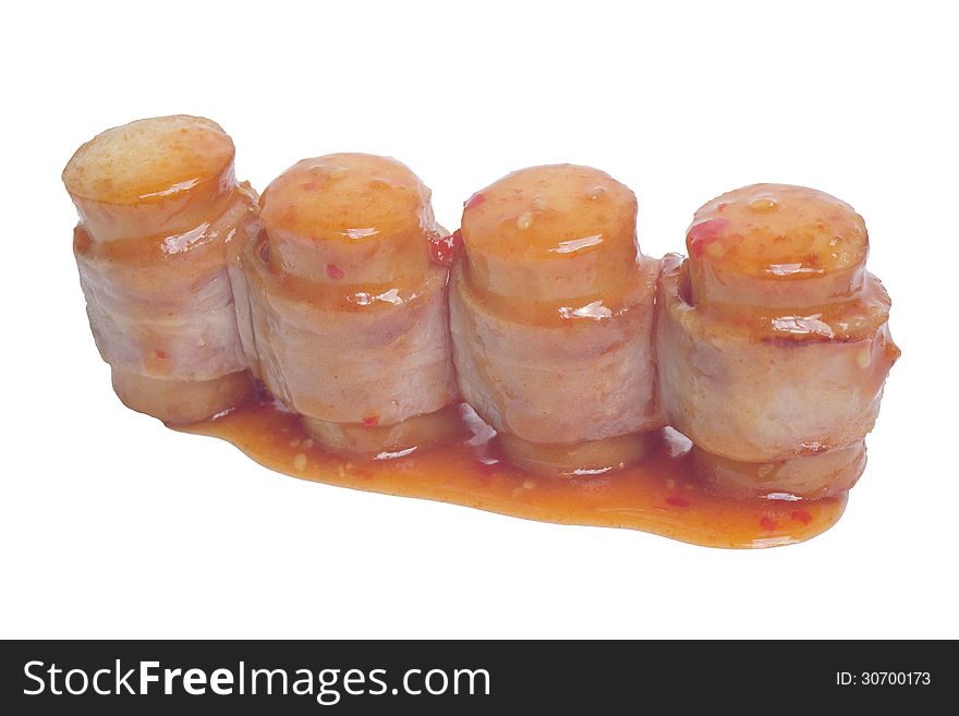 Closeup of hot dog with sauce on a white background