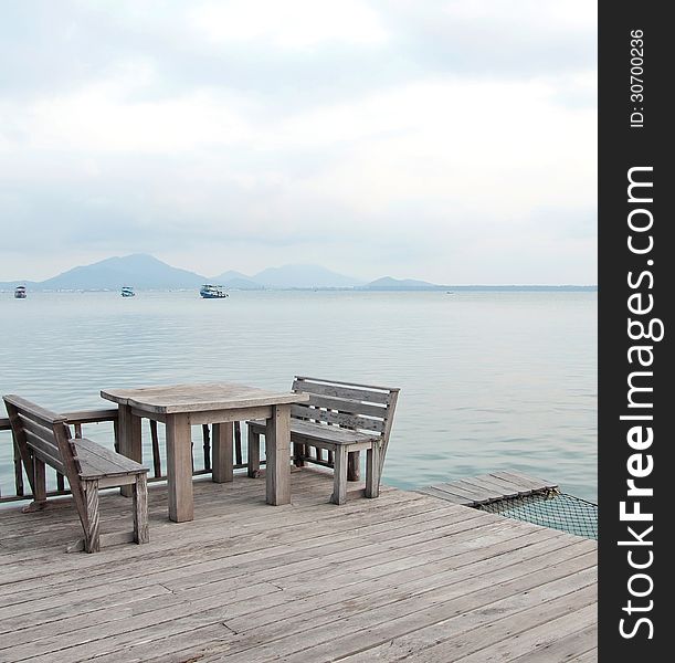 Wooden table and chairs on a tropical beach resort