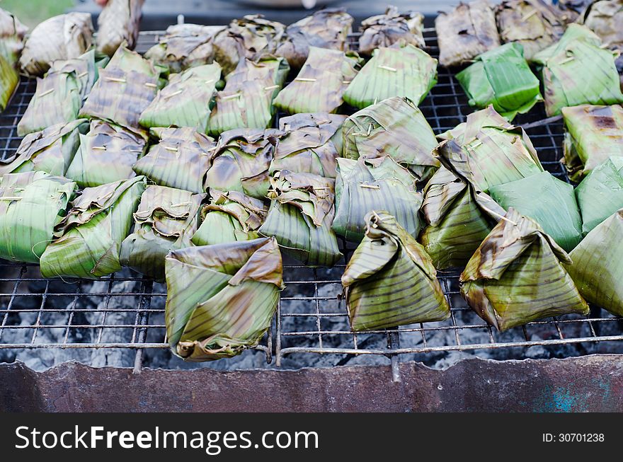 Fish with curry paste wrapped in banana leaves, grilled on charcoal. Fish with curry paste wrapped in banana leaves, grilled on charcoal.