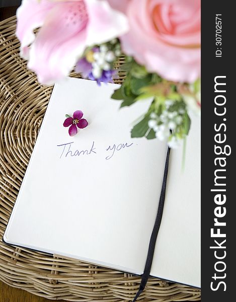 Thank you note on white page with pink blossom. Thank you note on white page with pink blossom