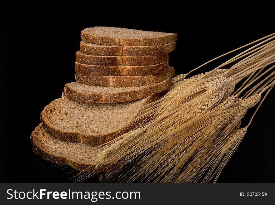 Wheat bread with stalks of wheat. Wheat bread with stalks of wheat.