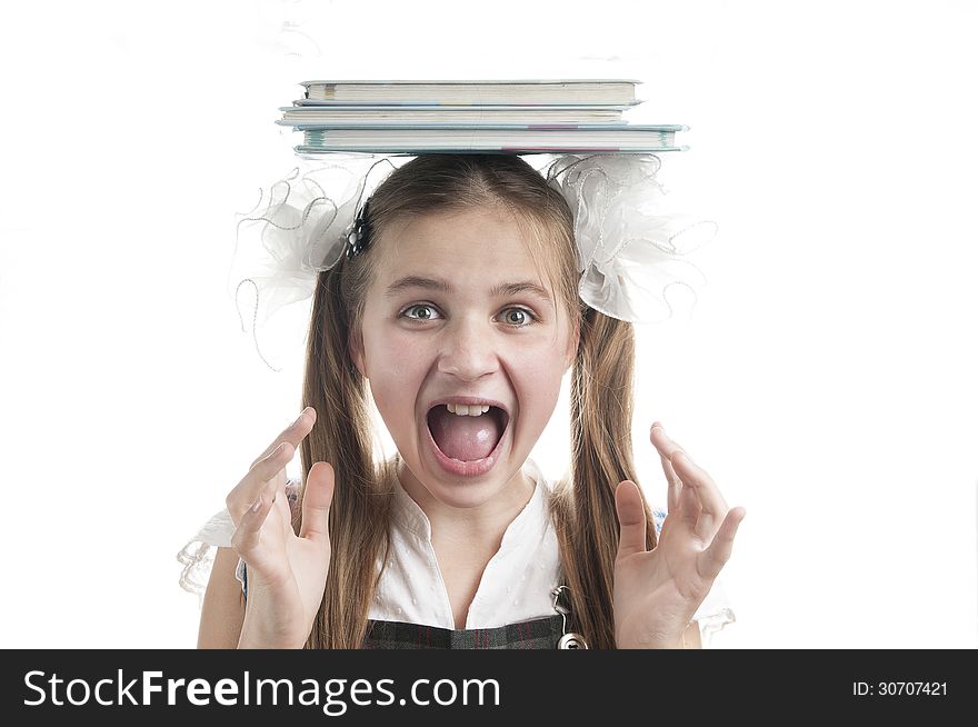 Crazy schoolgirl with textbooks on her head over white background. Crazy schoolgirl with textbooks on her head over white background.