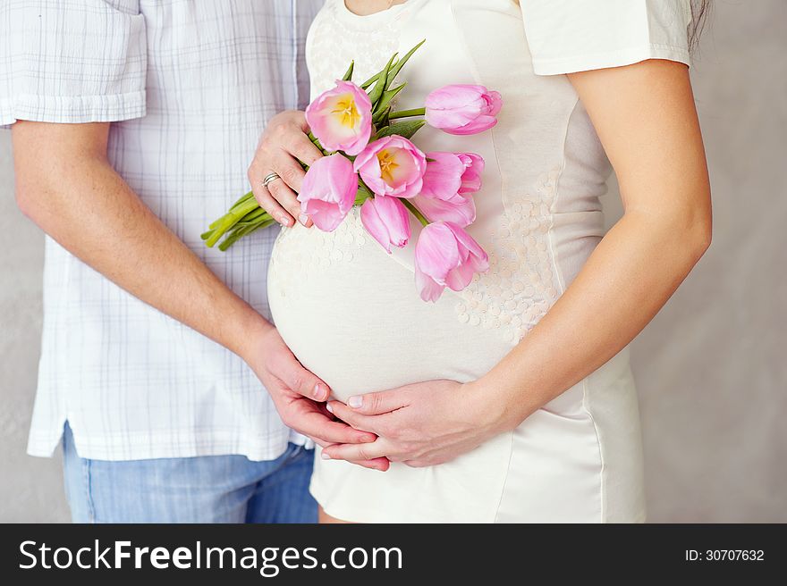 Pregnant woman belly with tulips. Pregnant woman belly with tulips