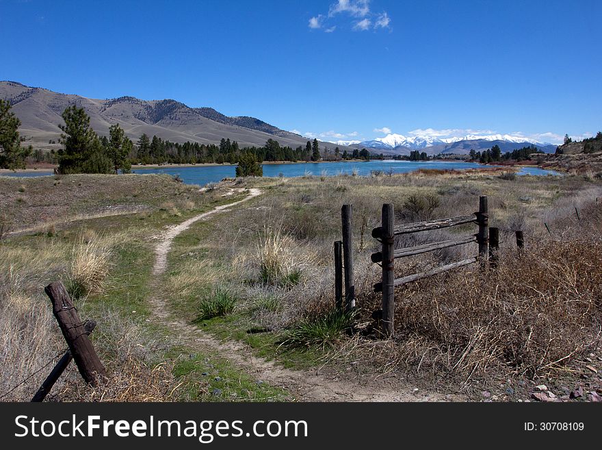 This image shows an angler's access site to the Flathead River with the snowy Mission Mountains of Montana in the background. This image shows an angler's access site to the Flathead River with the snowy Mission Mountains of Montana in the background.