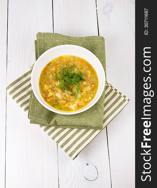 Yellow Pea Soup In Bowl On White Wooden Background