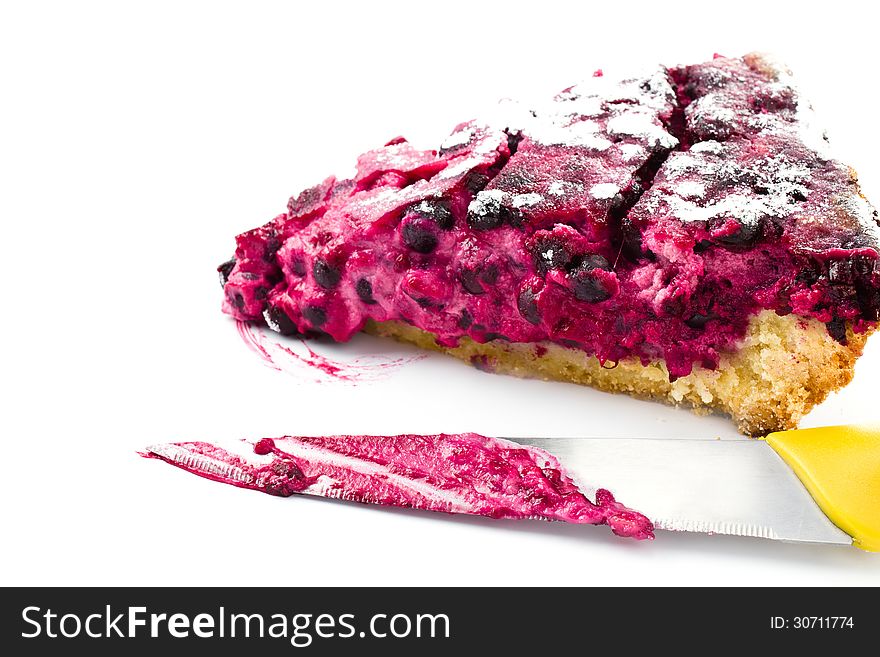 A piece of blueberry pie and knife isolated on white background