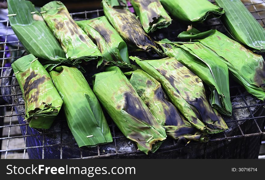 Toast sticky rice on a banana leaf