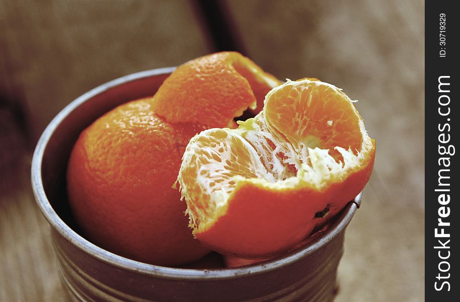 Tangerines on a natural wooden table. Photo in old image style.