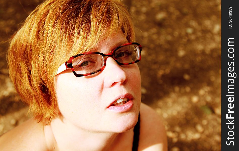 Close up portrait of attractive redheaded woman. Focus on the eyes.