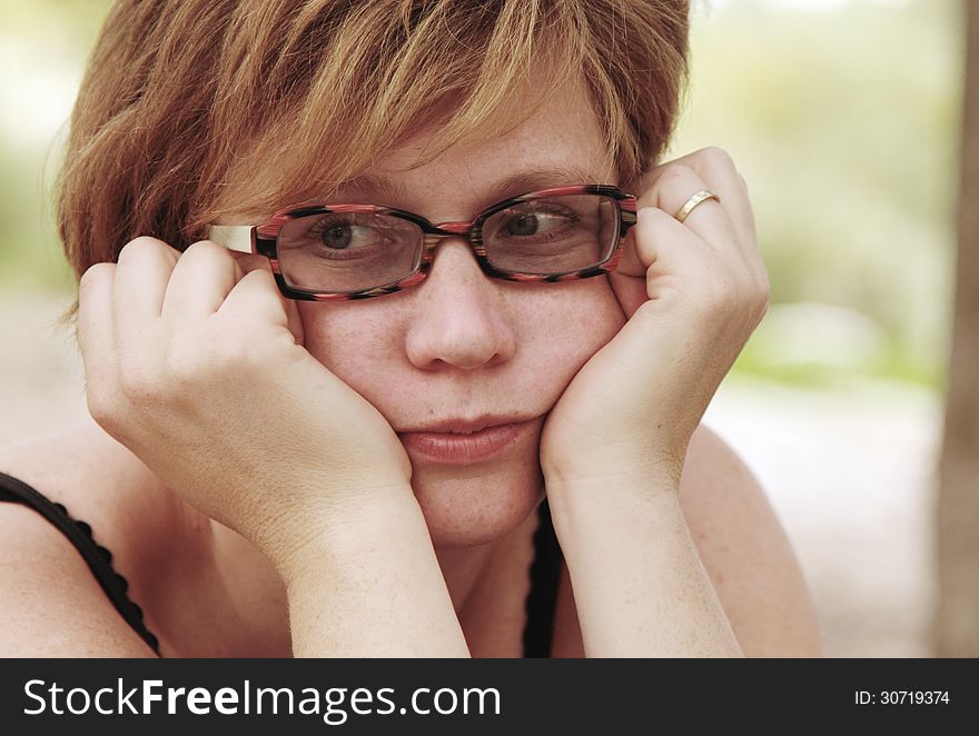 Close up portrait of sad redheaded woman