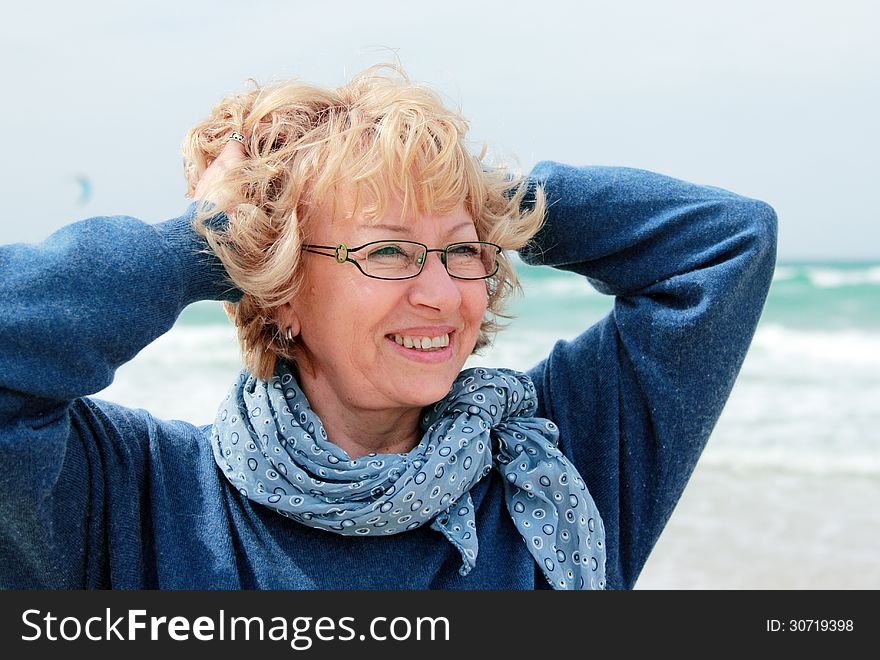 Portrait of happy senior woman at sea