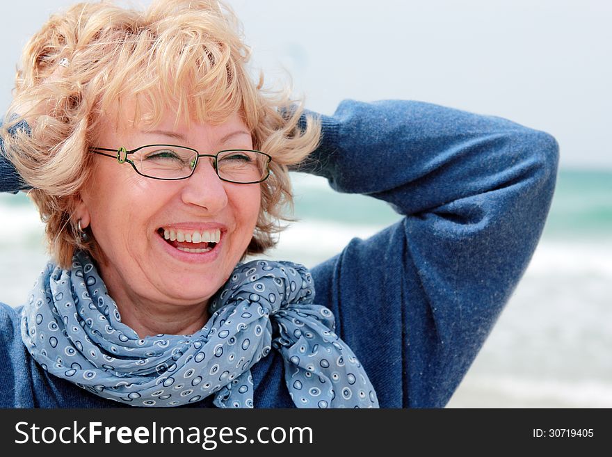 Portrait of happy senior woman at sea