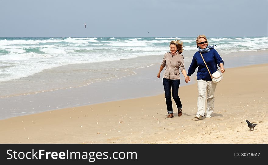 Mother and daughter on a winter beach