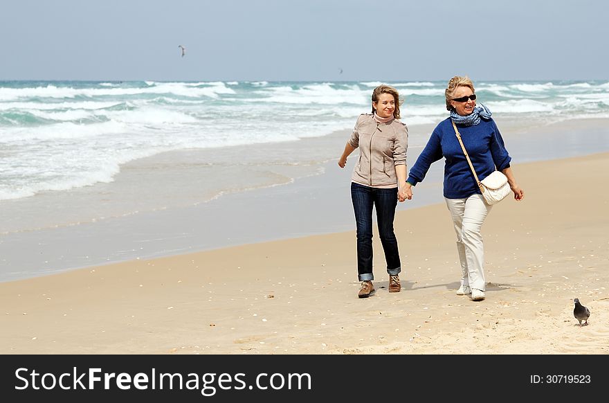 Mother and daughter on a winter beach