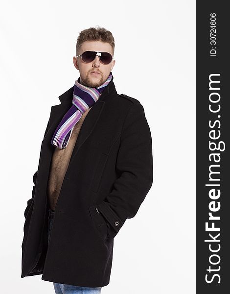 Portrait of handsome stylish blond man in sunglasses and a coat over her naked body in a beautiful stylish scarf