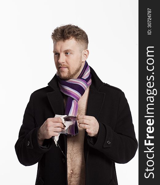 Portrait of handsome stylish blond man in sunglasses and a coat over her naked body in a beautiful stylish scarf
