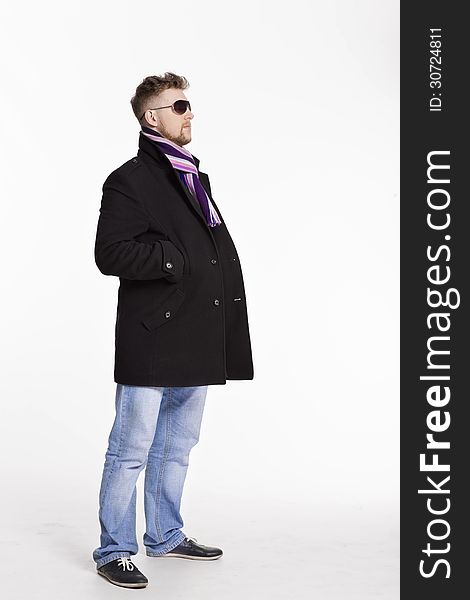 Portrait of handsome stylish blond man in sunglasses and a coat over her naked body in a beautiful stylish scarf