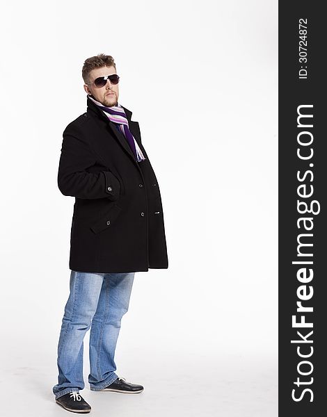 Portrait Of Handsome Stylish Blond Man In Sunglasses And A Coat