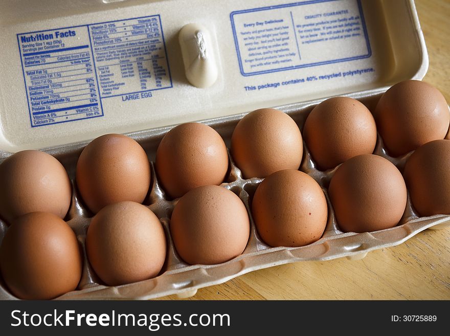 A dozen brown eggs, sometimes called country eggs.