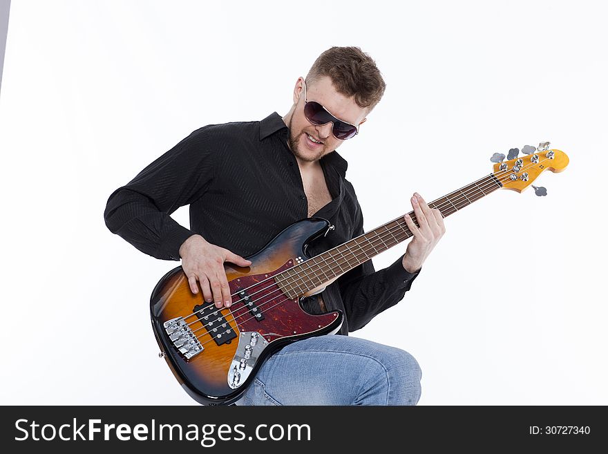 Bass player with attitude playing guitar gently in love with music