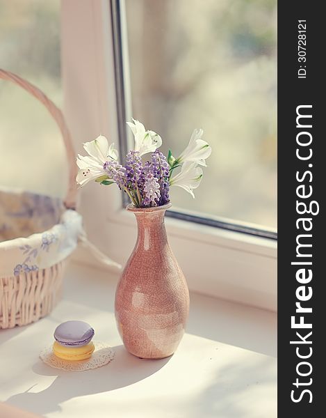 The sun on the window sill delicate bouquet in pink vase. The sun on the window sill delicate bouquet in pink vase