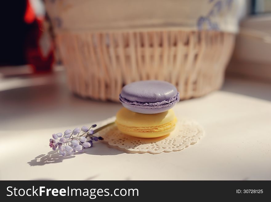 Against the background of a wicker basket on a white napkin round two piece of soap and a flower. Against the background of a wicker basket on a white napkin round two piece of soap and a flower