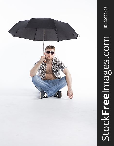 Young athletic businessman under umbrella