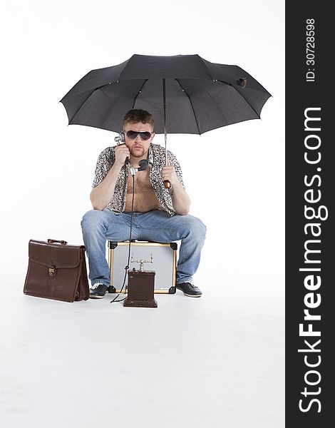 Young businessman under umbrella on vacation. Young businessman under umbrella on vacation