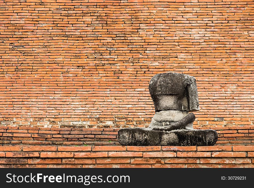 Frontal view of a Buddha statue without head in Ayutthaya, the ancient capital of Thailand.