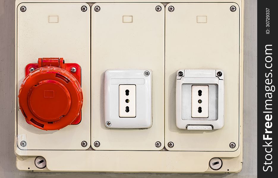 Frontal close up of electric sockets with a red protection. Frontal close up of electric sockets with a red protection.