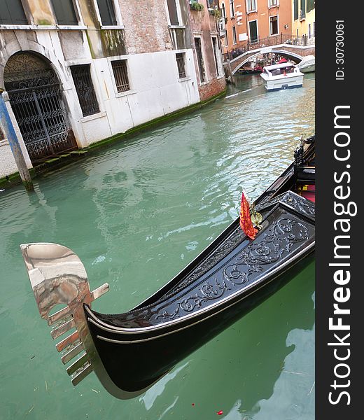 Venice - a detailed view of a gondola on the small town canal. Venice - a detailed view of a gondola on the small town canal
