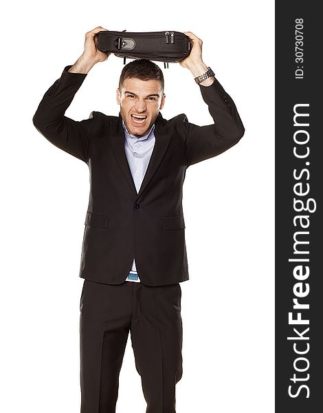 Attractive young businessman screaming with a laptop bag over his head