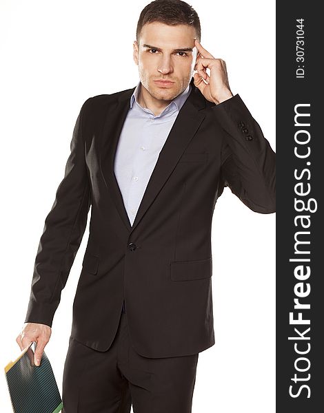 Furious young businessman with folder in hand pointing a finger at the head. Furious young businessman with folder in hand pointing a finger at the head