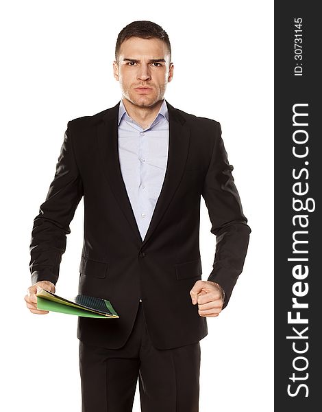 Furious young businessman with folder in hand. Furious young businessman with folder in hand