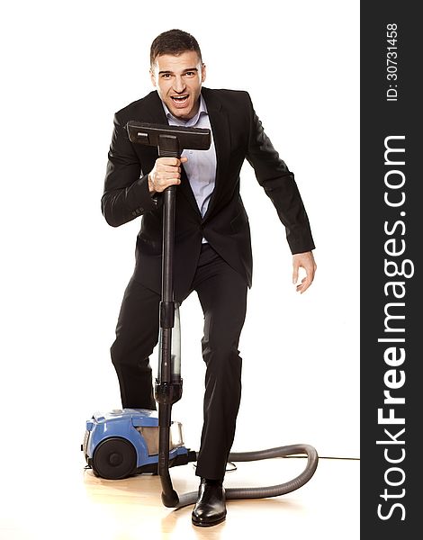 Young attractive businessman with a vacuum cleaner. Young attractive businessman with a vacuum cleaner