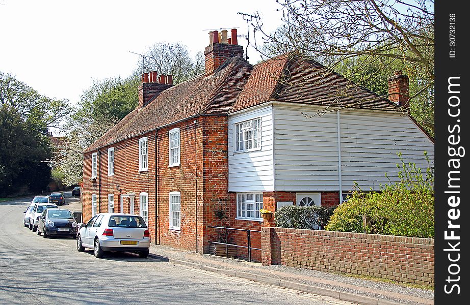 Photo of red brick cottages with white weatherboarding in the tranquil village of harbledown in rural kent. photo taken 1st may 2013. Photo of red brick cottages with white weatherboarding in the tranquil village of harbledown in rural kent. photo taken 1st may 2013.